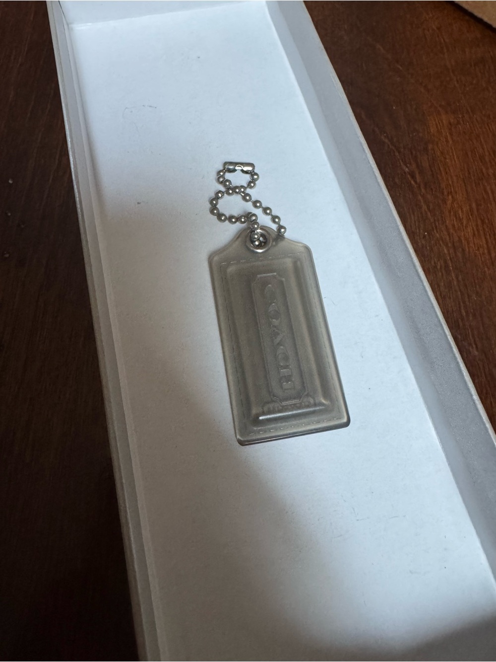 Coach hangtag is made of clear acrylic plastic